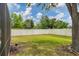 Well-maintained fenced backyard featuring a lush green lawn and mature trees, providing privacy and a serene atmosphere at 5561 Burnt Branch Cir, Sarasota, FL 34232