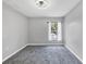 Neutral empty bedroom featuring carpet, a ceiling fan, and a window at 5561 Burnt Branch Cir, Sarasota, FL 34232