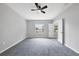 Neutral bedroom featuring carpet, ceiling fan, and natural light at 5561 Burnt Branch Cir, Sarasota, FL 34232