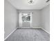 Neutral empty bedroom featuring carpet, a ceiling fan, and a window at 5561 Burnt Branch Cir, Sarasota, FL 34232