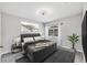 Neutral bedroom featuring a bed, large window, and coordinating décor at 5561 Burnt Branch Cir, Sarasota, FL 34232