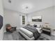 Neutral bedroom featuring a bed, chair, large window, and coordinating décor at 5561 Burnt Branch Cir, Sarasota, FL 34232