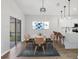 Stylish dining area featuring a modern table setting and a view of the kitchen bar, perfect for entertaining guests at 5561 Burnt Branch Cir, Sarasota, FL 34232