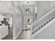 Bright entryway featuring a staircase and view through glass front door at 5561 Burnt Branch Cir, Sarasota, FL 34232