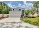 Two-story home with a well-manicured lawn, two car garage, and mature landscaping at 5561 Burnt Branch Cir, Sarasota, FL 34232