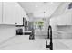The kitchen features quartz countertops, stainless steel appliances, and white cabinets at 5561 Burnt Branch Cir, Sarasota, FL 34232