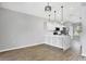 Bright kitchen features white cabinets, quartz countertops, stainless steel appliances, and wood-look flooring at 5561 Burnt Branch Cir, Sarasota, FL 34232