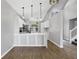 Bright kitchen with white cabinets, stainless steel appliances, and wood-look flooring at 5561 Burnt Branch Cir, Sarasota, FL 34232
