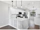 Bright kitchen features white cabinets, stainless steel appliances, and a quartz countertop island at 5561 Burnt Branch Cir, Sarasota, FL 34232
