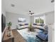 Bright living room showcasing a ceiling fan, two sofas, and an accent rug at 5561 Burnt Branch Cir, Sarasota, FL 34232