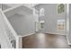Open-concept living space highlighted by tall ceilings, abundant windows, and a staircase to the second floor at 5561 Burnt Branch Cir, Sarasota, FL 34232