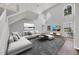 Bright living room with soaring ceilings, large windows, and a comfortable seating area, showcasing modern decor at 5561 Burnt Branch Cir, Sarasota, FL 34232