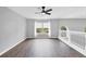 Upstairs loft area features wood flooring and a large window with scenic views at 5561 Burnt Branch Cir, Sarasota, FL 34232