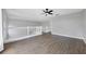 Loft area features laminate flooring, a ceiling fan, and white railing at 5561 Burnt Branch Cir, Sarasota, FL 34232