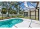 Inviting screened-in pool with a spacious backyard, ideal for outdoor relaxation and entertainment at 5561 Burnt Branch Cir, Sarasota, FL 34232