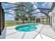 A refreshing kidney-shaped pool with a screened enclosure and sunny backyard creates an inviting outdoor oasis at 5561 Burnt Branch Cir, Sarasota, FL 34232
