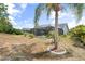 Exterior view of the home's backyard featuring an enclosed pool, desert landscaping and sunny skies at 5750 Carriage Dr, Sarasota, FL 34243