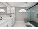 Modern bathroom with double vanity and a glass-enclosed shower at 5750 Carriage Dr, Sarasota, FL 34243