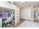 Bright bedroom features a white loft bed with desk, closet and a colorful rug in the space at 5750 Carriage Dr, Sarasota, FL 34243