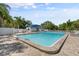A refreshing community pool surrounded by lounge chairs and tropical landscaping at 5750 Carriage Dr, Sarasota, FL 34243