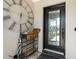 Home entryway featuring decorative front door, accent table with large clock and umbrella stand at 5750 Carriage Dr, Sarasota, FL 34243