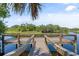 Fishing dock on the lake with wooden posts and railings at 5750 Carriage Dr, Sarasota, FL 34243