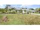 Charming single-story home featuring lush landscaping, a well-manicured lawn, and a welcoming entrance at 5750 Carriage Dr, Sarasota, FL 34243