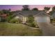 Charming single-story home with a well-manicured lawn, a two car garage and lush tropical landscaping at 5750 Carriage Dr, Sarasota, FL 34243