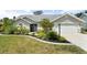 Charming single-story home with a well-manicured lawn, a two car garage and lush tropical landscaping at 5750 Carriage Dr, Sarasota, FL 34243