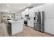 Bright kitchen features stainless steel appliances, white cabinets, and a large island with seating at 5750 Carriage Dr, Sarasota, FL 34243