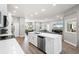 Open-concept kitchen and living area featuring a large island and stainless steel appliances at 5750 Carriage Dr, Sarasota, FL 34243