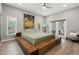 Spacious main bedroom featuring a platform bed and French doors to the pool at 5750 Carriage Dr, Sarasota, FL 34243