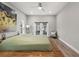 Bright main bedroom with a modern ceiling fan and access to the pool at 5750 Carriage Dr, Sarasota, FL 34243