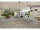Spacious screened-in outdoor seating area by the community pool with tables and ceiling fans at 5750 Carriage Dr, Sarasota, FL 34243