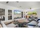 Bright sunroom with comfortable seating and views of the backyard and pool area at 5750 Carriage Dr, Sarasota, FL 34243