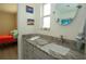 Cozy bathroom with a granite vanity top, oval mirror and access to the bedroom at 603 Saint Andrews Dr, Sarasota, FL 34243