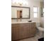 Bright bathroom featuring a wood framed mirror, modern vanity, and patterned tile flooring at 603 Saint Andrews Dr, Sarasota, FL 34243