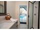 Stylish bathroom with a view of the outdoor pool area through door at 603 Saint Andrews Dr, Sarasota, FL 34243