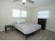 Bright bedroom with a ceiling fan, neutral walls, and wood-look flooring at 603 Saint Andrews Dr, Sarasota, FL 34243