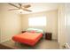 Cozy bedroom featuring neutral walls, ceiling fan and wood look flooring at 603 Saint Andrews Dr, Sarasota, FL 34243