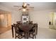 Traditional dining room with tile flooring, ceiling fan, and a dark wood dining set at 603 Saint Andrews Dr, Sarasota, FL 34243