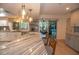 Modern kitchen with island and stylish pendant lighting; seamless transition to outdoor pool area at 603 Saint Andrews Dr, Sarasota, FL 34243