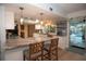 Modern kitchen with breakfast bar, pendant lighting, and views of the pool area at 603 Saint Andrews Dr, Sarasota, FL 34243