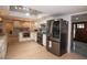 Spacious open kitchen featuring stainless steel appliances, white cabinetry and modern lighting at 603 Saint Andrews Dr, Sarasota, FL 34243