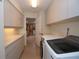 Bright laundry room with ample cabinetry and modern washer/dryer units at 603 Saint Andrews Dr, Sarasota, FL 34243