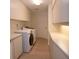 Well lit laundry room featuring modern appliances, white cabinets and ample countertop space at 603 Saint Andrews Dr, Sarasota, FL 34243