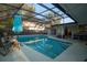 Gorgeous screened-in pool area featuring a large in-ground pool, lounge seating and hot tub for ultimate relaxation at 603 Saint Andrews Dr, Sarasota, FL 34243