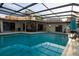Enjoy this beautiful, screened-in pool with ample seating and an open view of the backyard at 603 Saint Andrews Dr, Sarasota, FL 34243