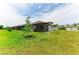 Lovely backyard featuring a screened-in lanai and well-maintained lawn with new plantings at 6094 Amberly Dr, Bradenton, FL 34208
