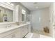 Modern bathroom with double vanity, granite countertop, a shower, and pebble floor at 6094 Amberly Dr, Bradenton, FL 34208